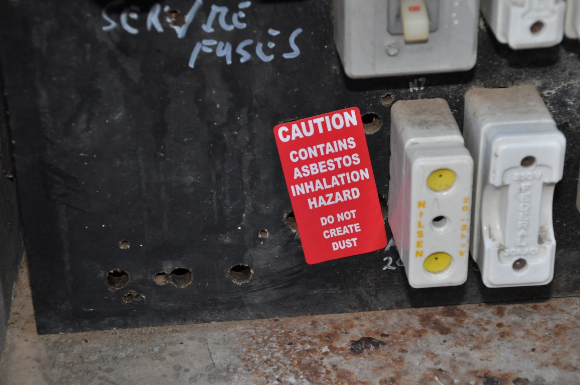 Bituminous electrical backing board and asbestos Asbestos